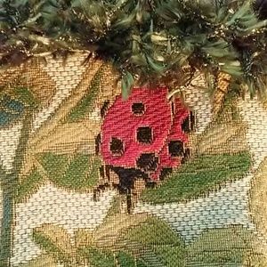 Lady bug bag with plaid straps and fringe in front